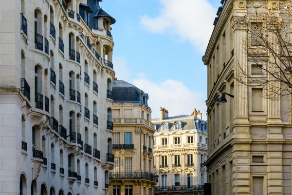 Rue parisienne avec immeubles haussmanniens, un cadre recherché pour l’investissement locatif.