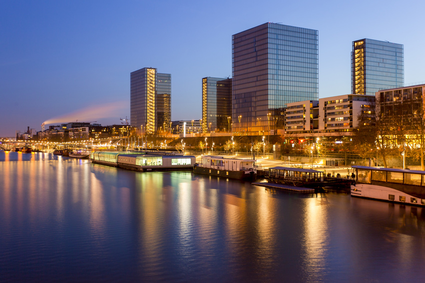 The François-Mitterrand Library, at the heart of the modern Paris Rive Gauche district, lighting up the Seine at dusk