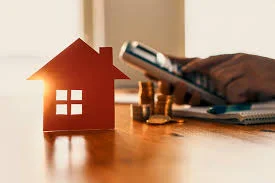 Une femme devant sa baie vitrée en train de lire les règlements du déficit foncier