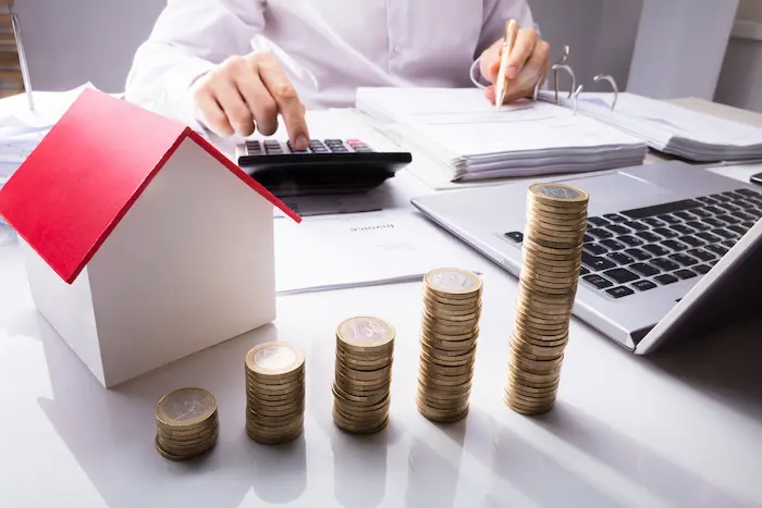 Photo d'un investisseur expatrié analysant des rapports financiers pour évaluer les avantages fiscaux de l'investissement immobilier à l'étranger.